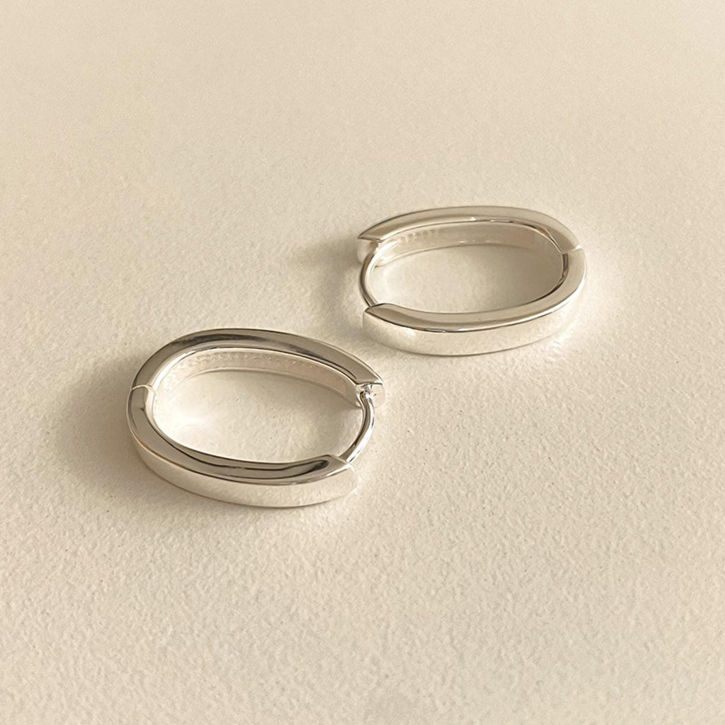 Sleek Oval Silver Huggie Earrings