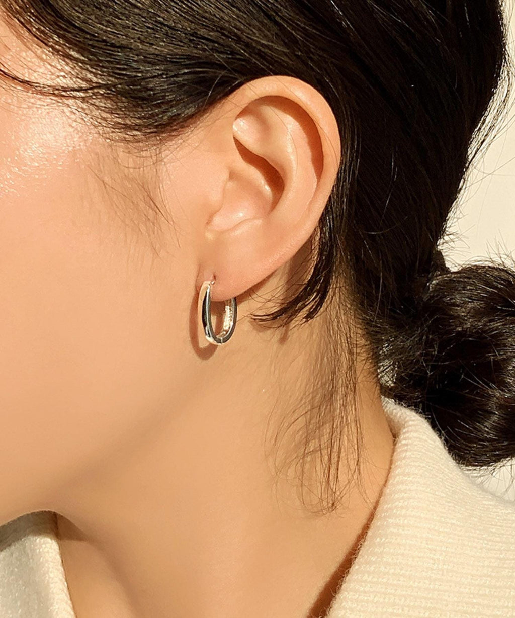 Sleek Oval Silver Huggie Earrings