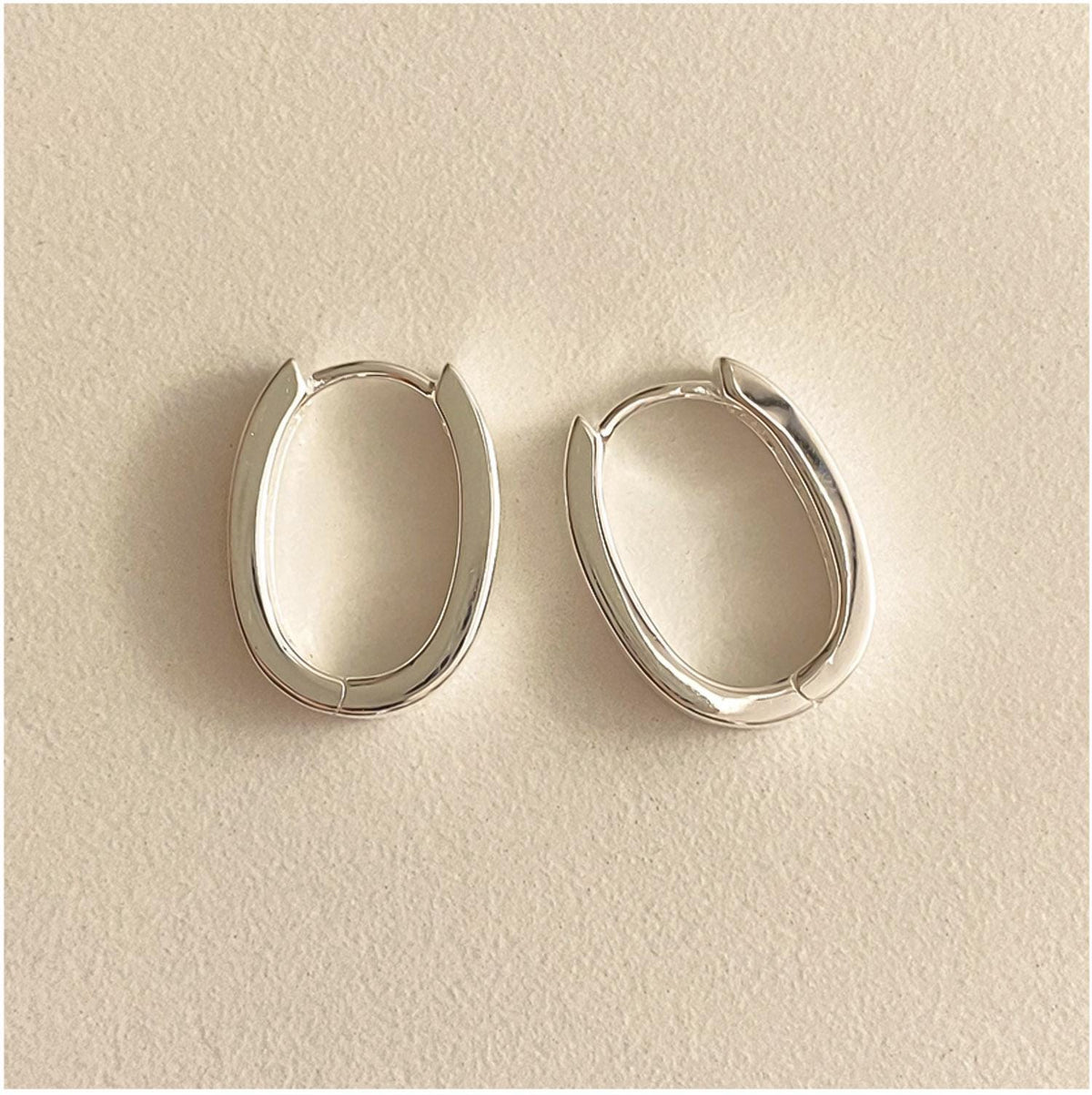 Sleek Oval Silver Huggie Earrings