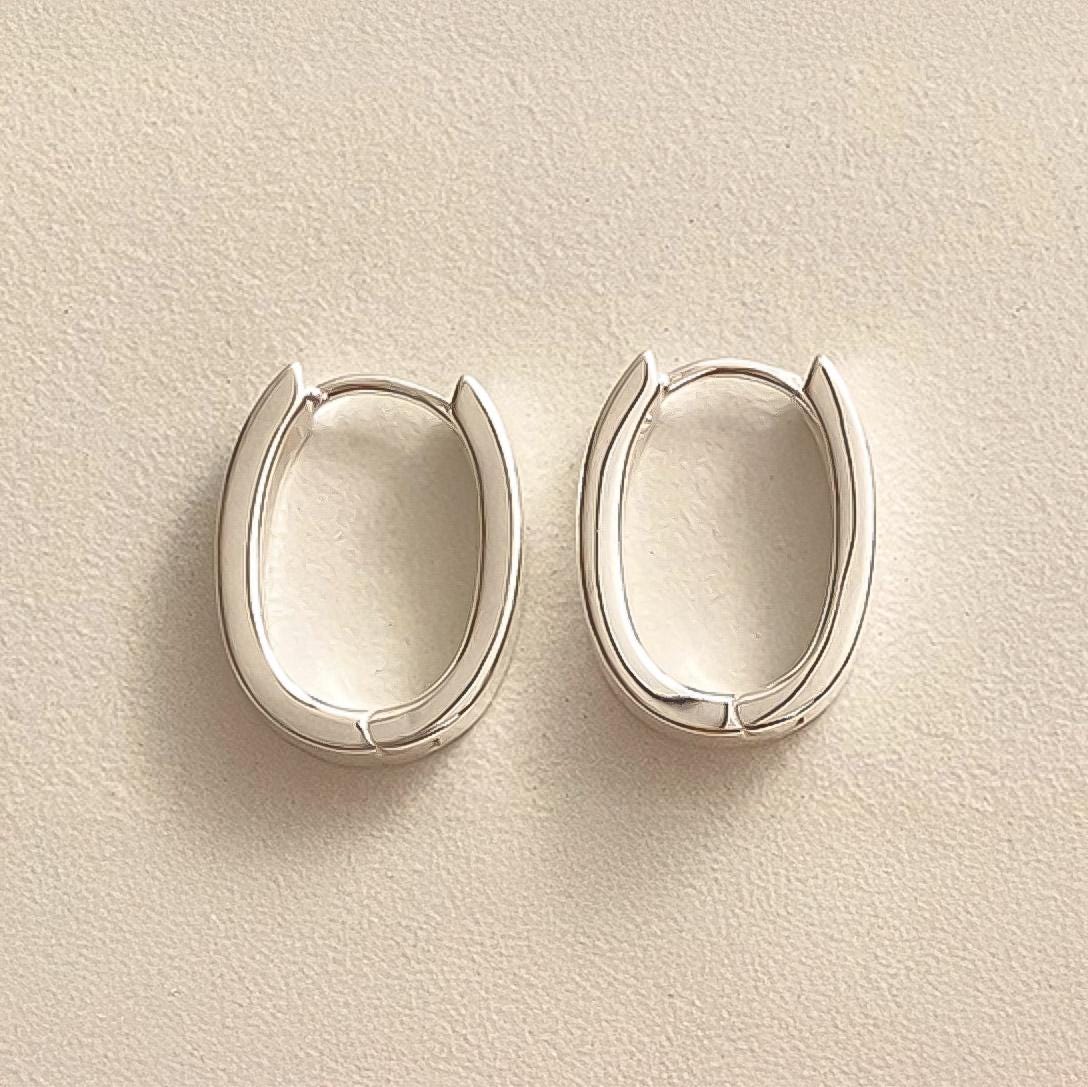 Sleek Oval Silver Huggie Earrings