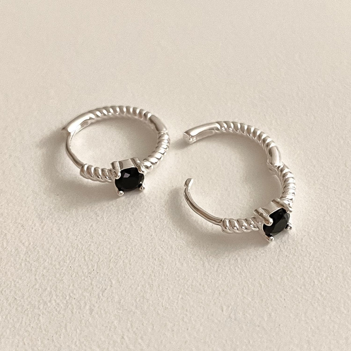 Twisted Silver Huggie Earrings with Black Stone