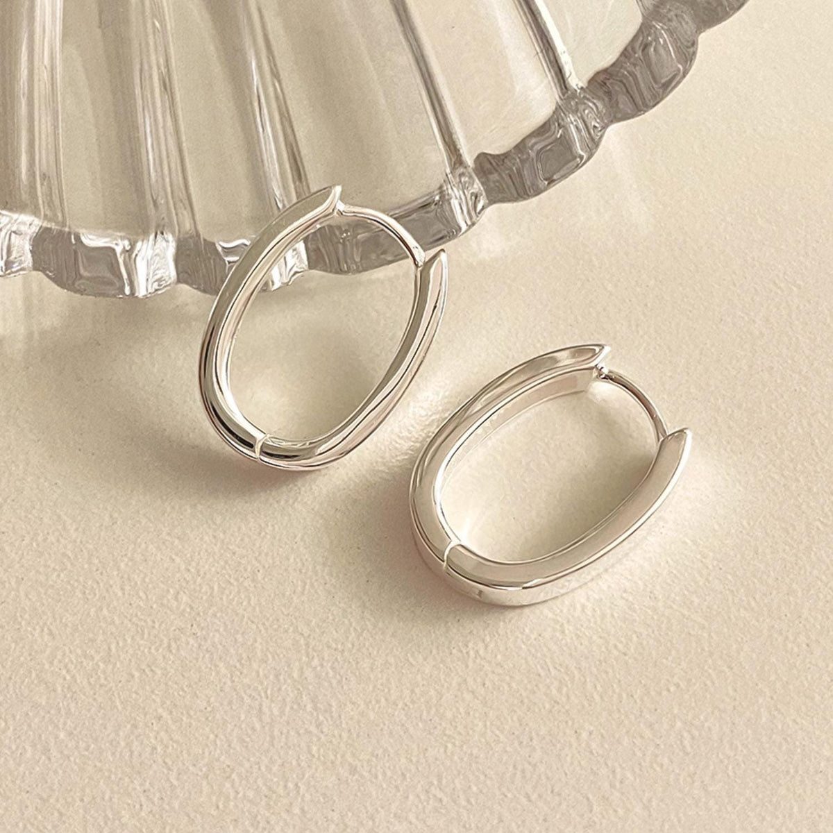 Sleek Oval Silver Huggie Earrings